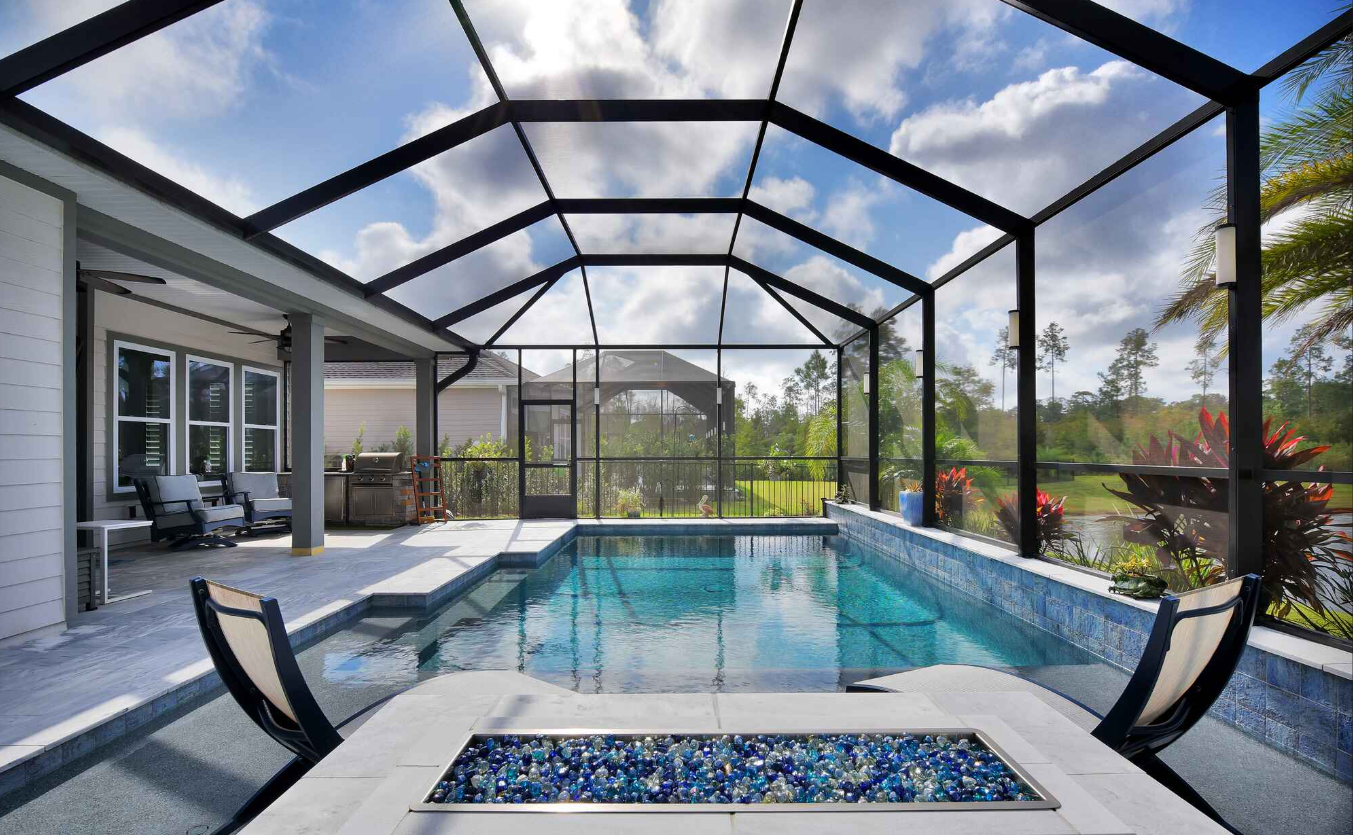 Tropical pool with screen enclosure and palm trees in Palm Beach